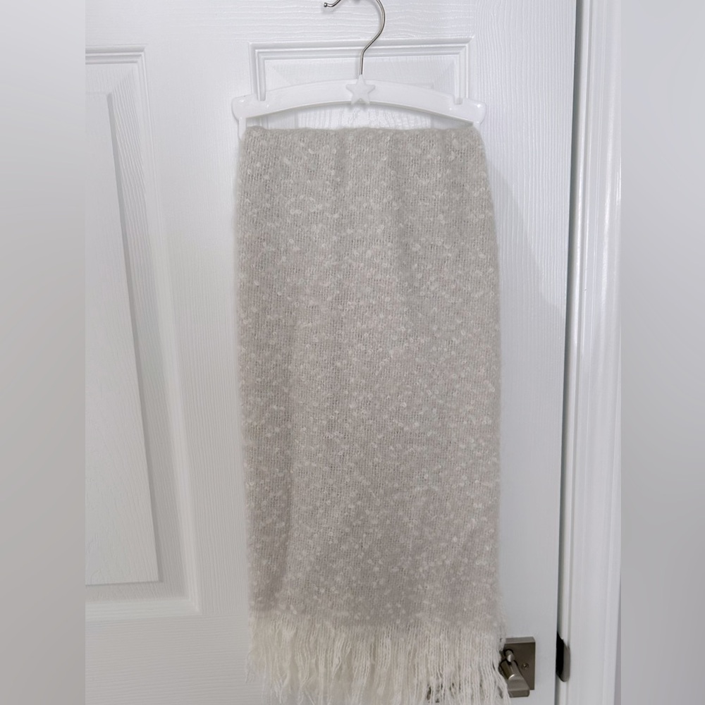 Adorable Baby throw in a tannish grey and white.